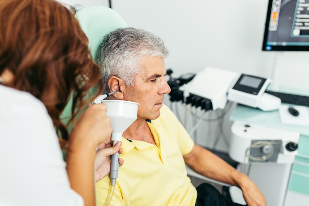 Senior man getting his ears examined