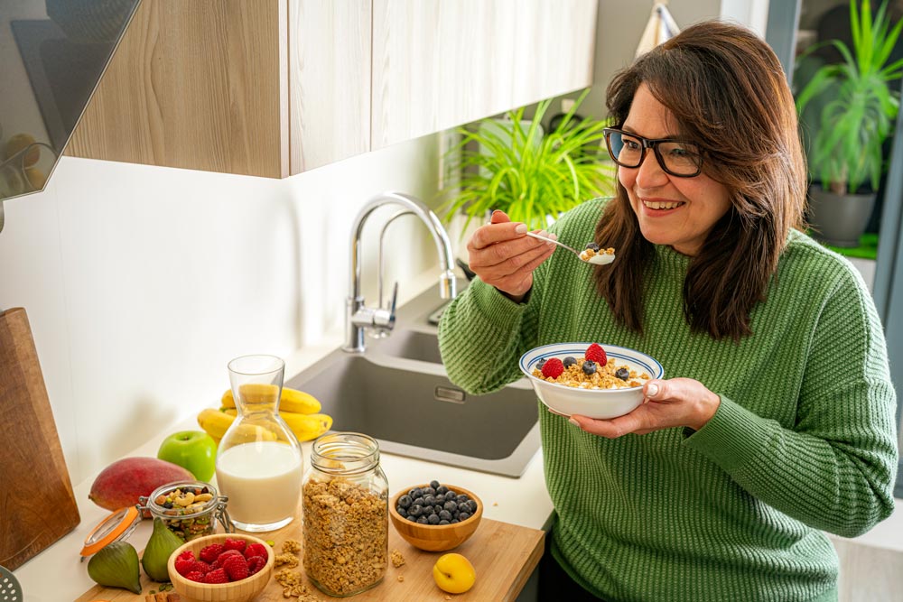 Happy woman eating a healthy snack