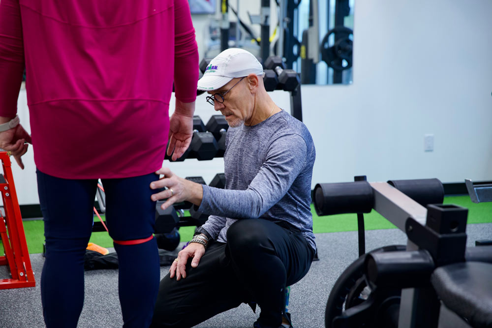 Personal trainer helping his client patient at Complete Wellness Physiotherapy building in St. Albert, AB
